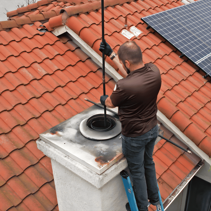 Roof Vent Installation by Titan21 Exteriors and Interiors Professional roof vent installation on a tiled roof with solar panel in background.