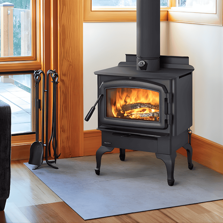 Wood stove with fire burning, located in a cozy living room corner for heating and ambiance.